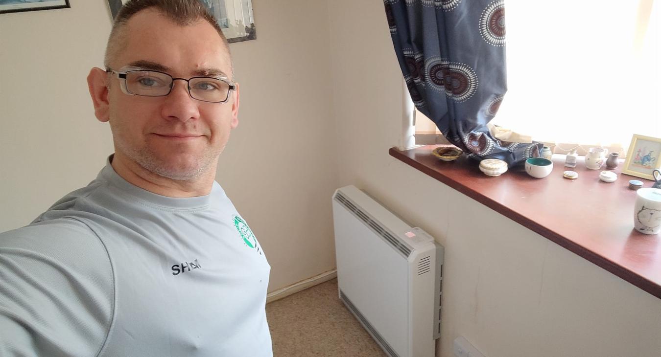 Electrician installing a storage heater