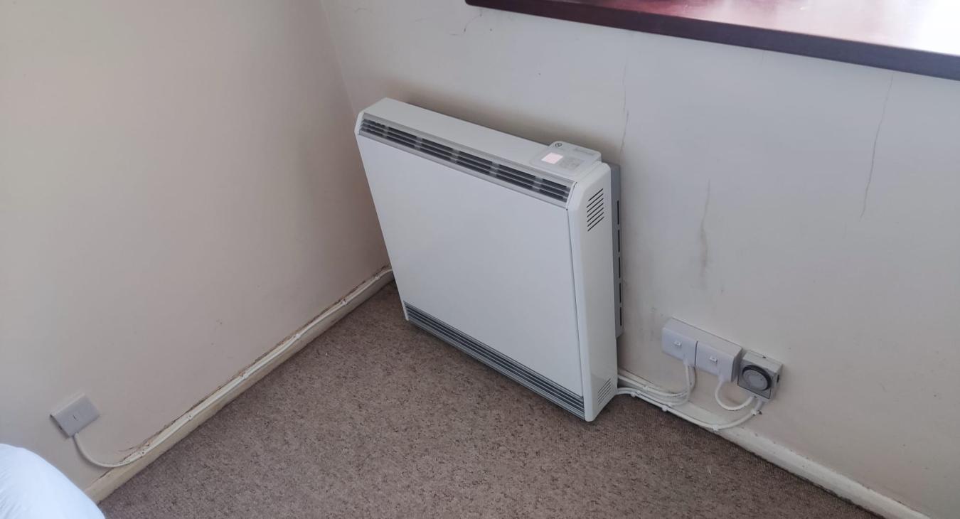 Electrician installing a storage heater