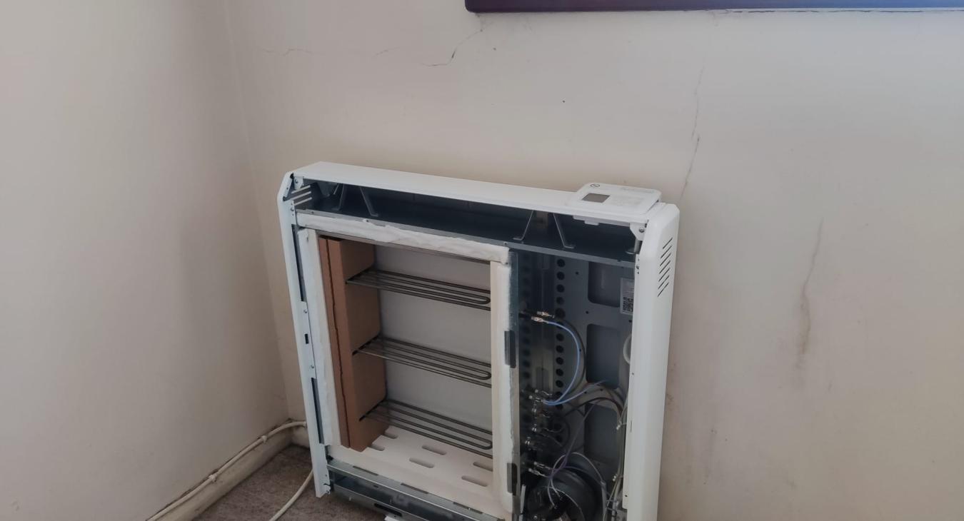Electrician installing a storage heater