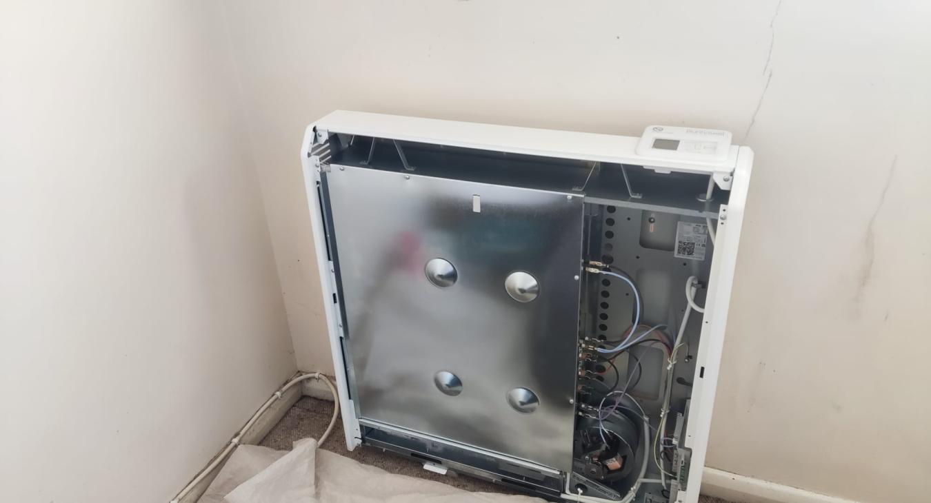 Electrician installing a storage heater